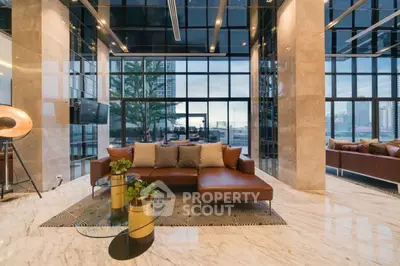 Luxurious modern living room with floor-to-ceiling windows and elegant decor.