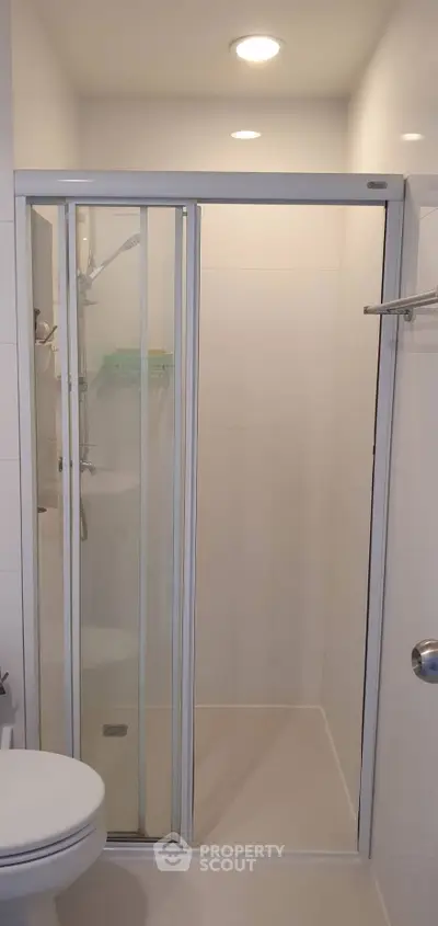 Modern bathroom with sleek shower enclosure and minimalist design.