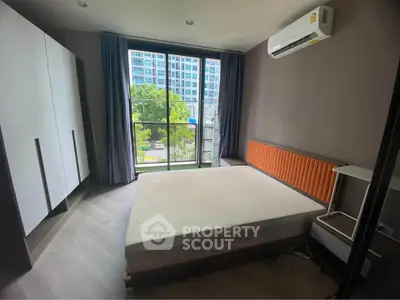 Modern bedroom with large window and air conditioning in urban apartment