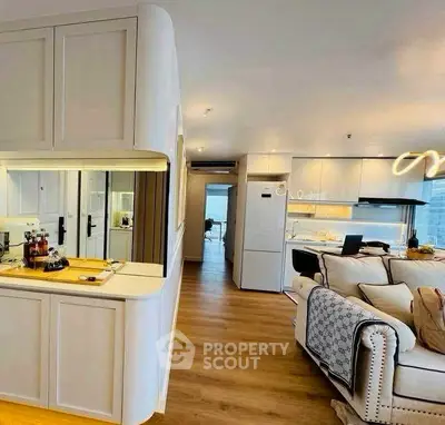 Modern open-layout living room with sleek kitchen and stylish decor