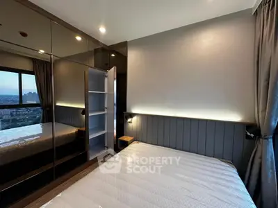 Modern bedroom with sleek mirrored wardrobe and city view