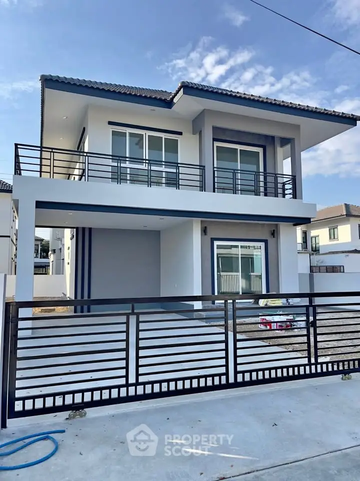 Modern two-story house with sleek design and spacious balcony in a serene neighborhood.