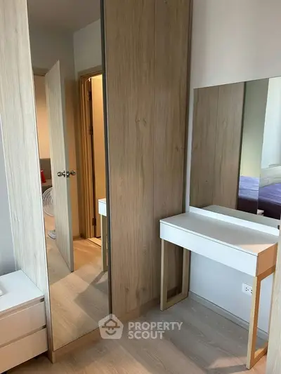 Modern bedroom with sleek wooden wardrobe and stylish vanity mirror