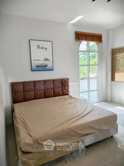 Bright and airy bedroom with large windows and modern decor