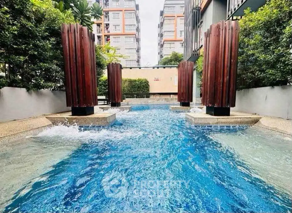 Luxurious outdoor pool area with modern design in a high-rise residential complex.