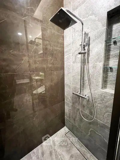 Luxurious modern bathroom with sleek shower design and elegant marble tiles.