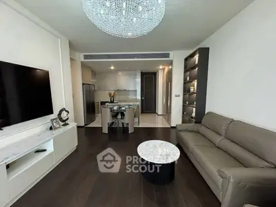 Modern living room with elegant chandelier and open kitchen layout