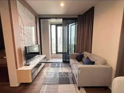 Modern living room with stylish decor and city view balcony, perfect for urban living.