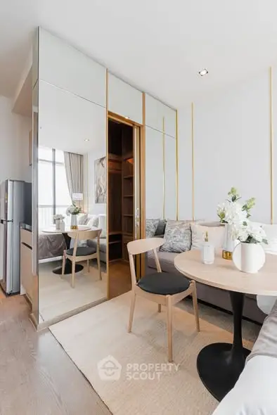 Modern studio apartment with elegant decor and mirrored wardrobe