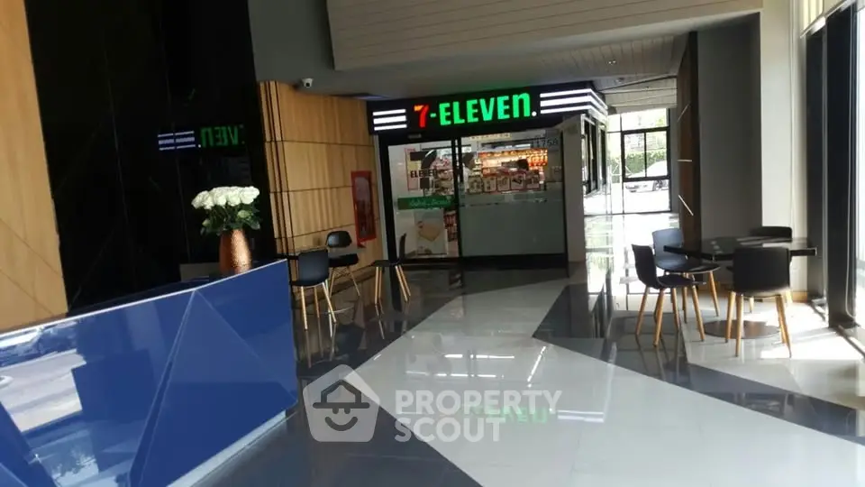 Modern commercial space with 7-Eleven store and stylish seating area.