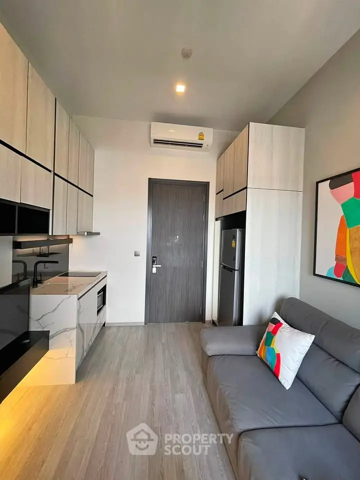 Modern compact living room with sleek kitchen and stylish decor