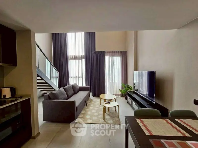 Modern living room with high ceilings and stylish decor