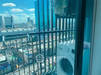 Modern high-rise balcony with city view and washing machine, perfect for urban living.
