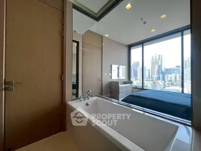 Luxurious bedroom with city view and modern bathtub, perfect urban living.