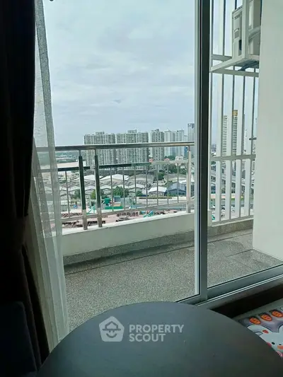 High-rise apartment balcony with stunning cityscape view, perfect for urban living.