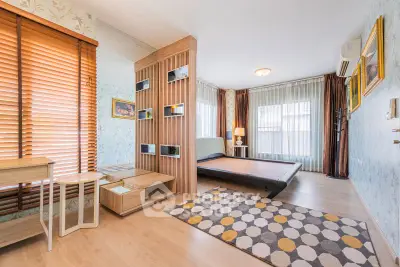 Spacious modern bedroom with stylish decor and large windows for natural light.