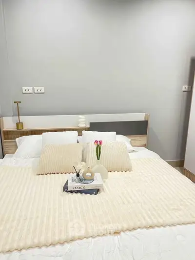Cozy bedroom with modern decor and plush bedding, perfect for relaxation.