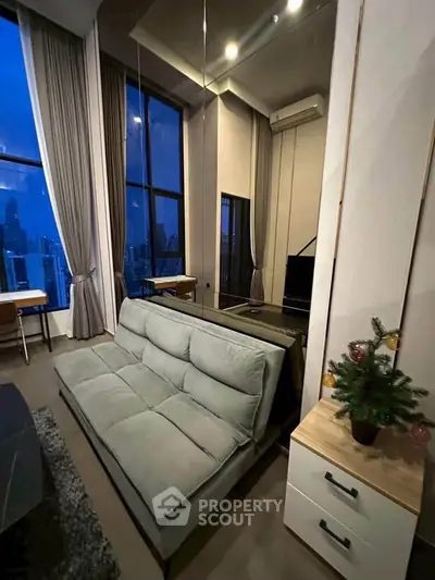 Modern living room with high ceilings and city view, featuring a stylish sofa and elegant decor.