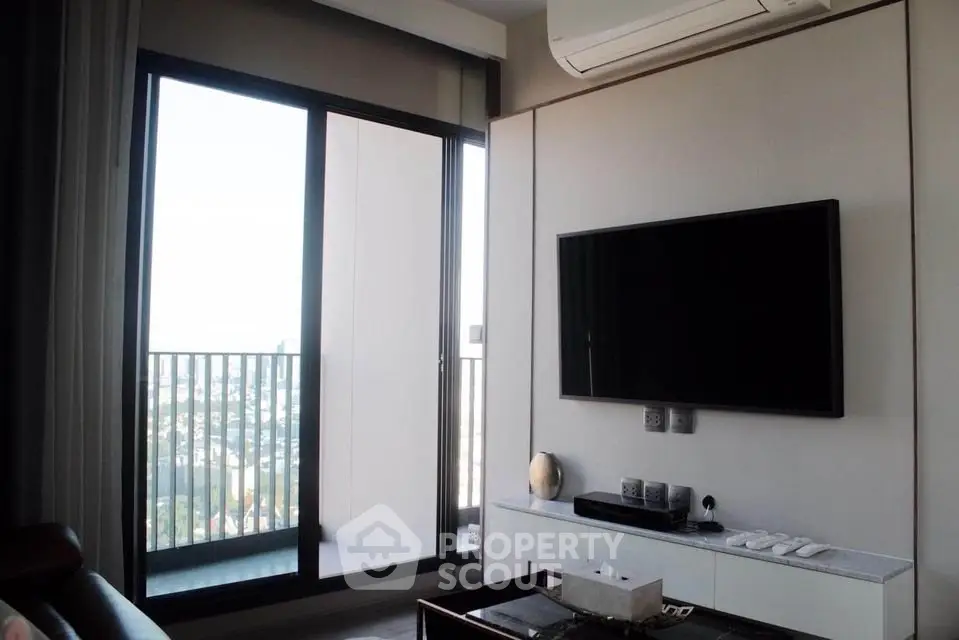 Modern living room with balcony view and wall-mounted TV in stylish apartment.