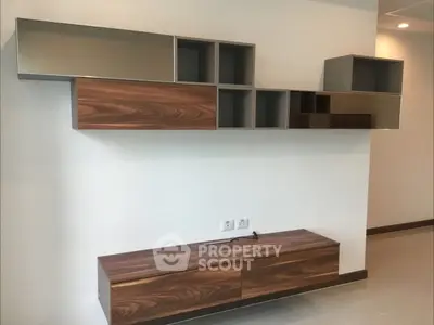 Modern wall-mounted storage unit with sleek wooden finish in a contemporary living space.