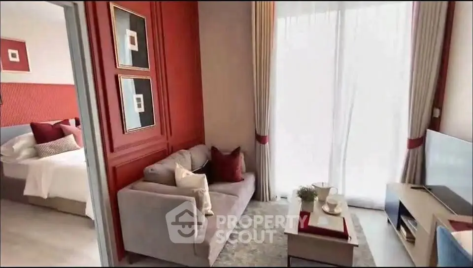 Stylish living room with modern decor and natural light, adjacent to a cozy bedroom.