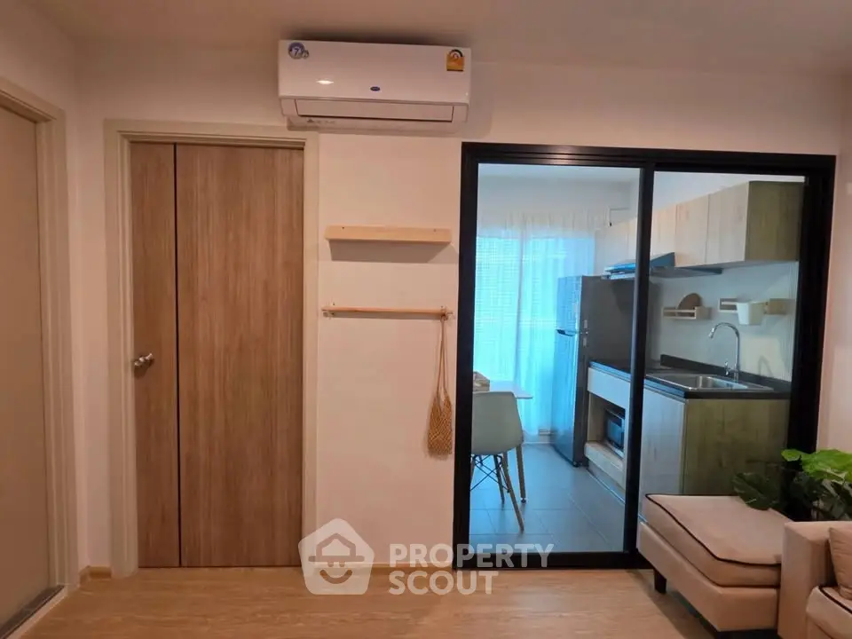 Modern apartment interior with air conditioning and open kitchen layout.