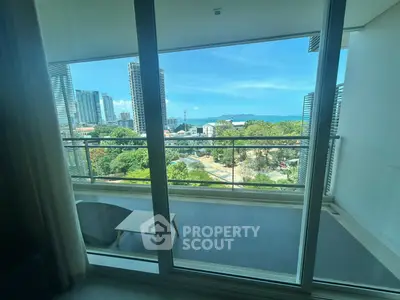Stunning balcony view with cityscape and ocean horizon, perfect for relaxation and enjoying sunsets.