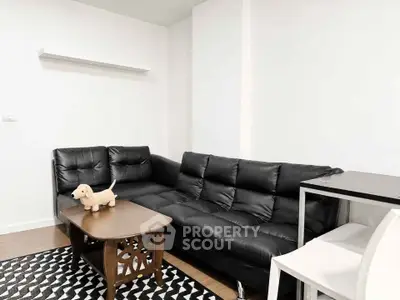 Modern living room with black leather sofa and stylish coffee table