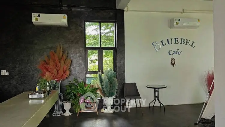 Chic cafe interior with modern decor and lush greenery