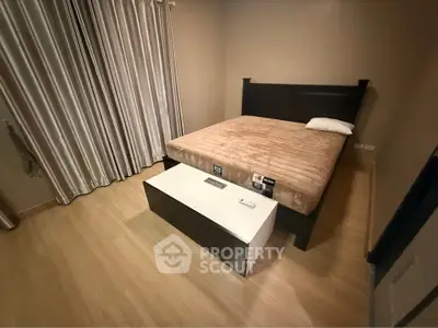 Cozy bedroom with modern furnishings and elegant curtains, perfect for restful nights.
