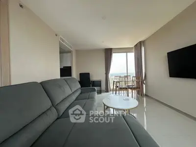 Spacious living room with modern sofa and large window view