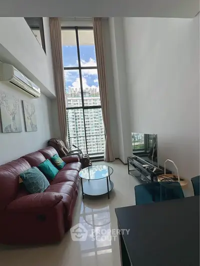 Spacious living room with high ceiling and stunning city view