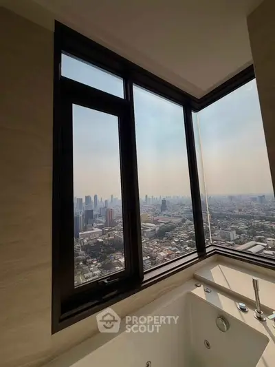 Luxurious bathroom with city skyline view from large corner window