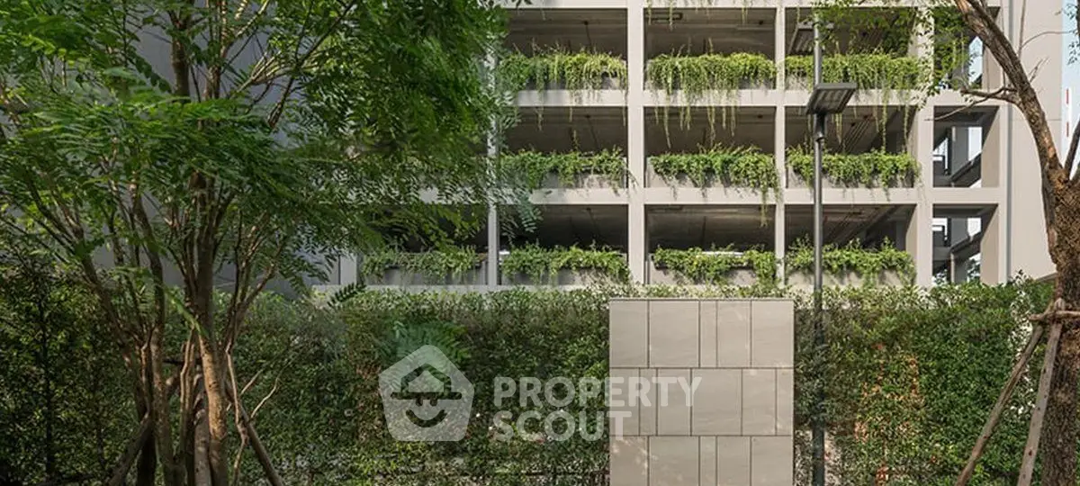 Modern building exterior with lush greenery and vertical garden design.