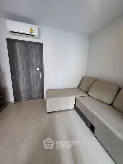 Modern living room with sleek sofa and air conditioning unit