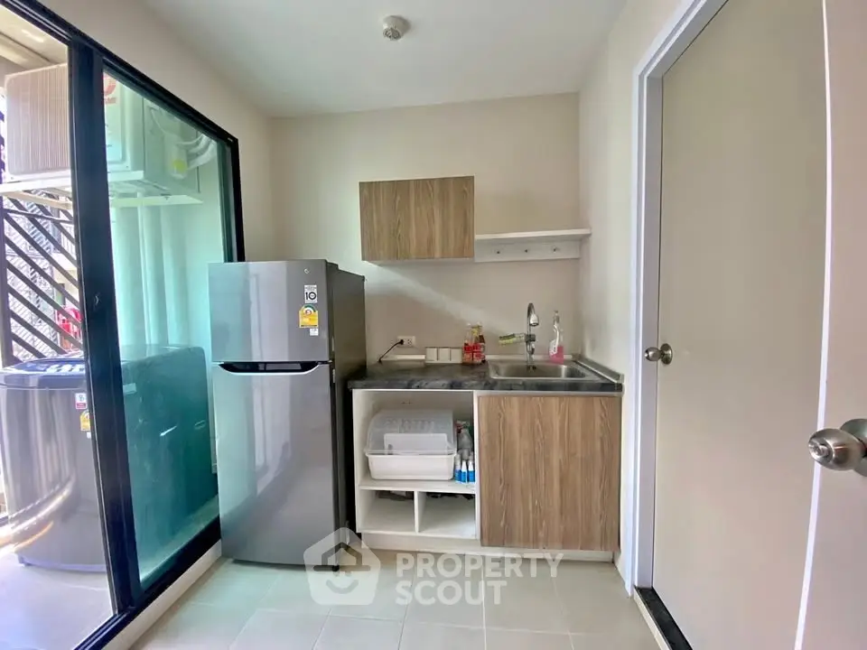 Compact kitchen with modern appliances and sleek cabinetry