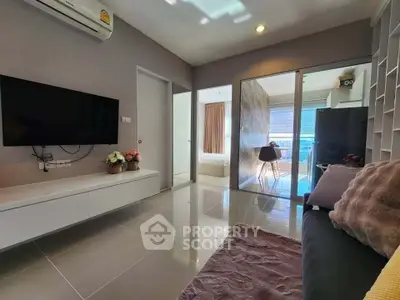 Modern living room with sleek design, featuring a wall-mounted TV, cozy sofa, and stylish decor.