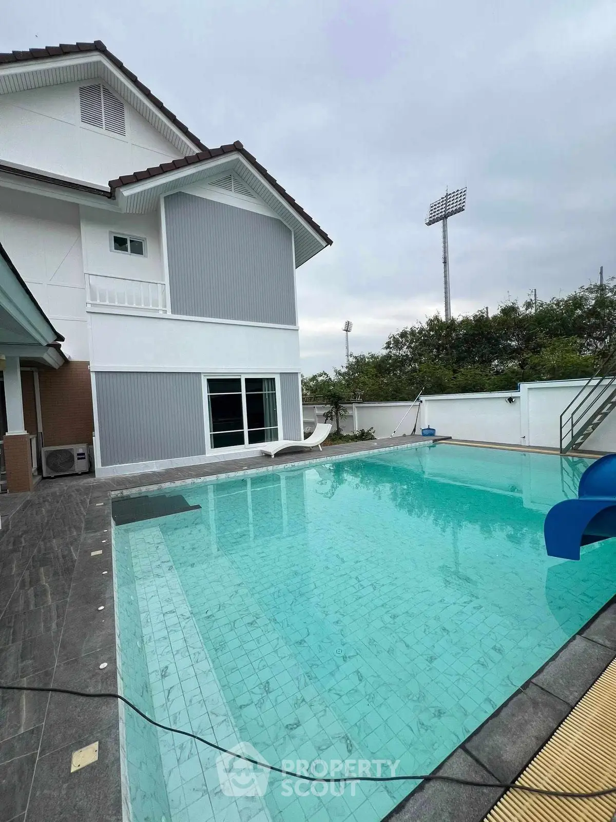 Luxurious modern home with a spacious pool and sleek exterior design, perfect for relaxation and entertainment.