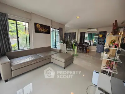 Spacious living room with modern decor and large windows for natural light.