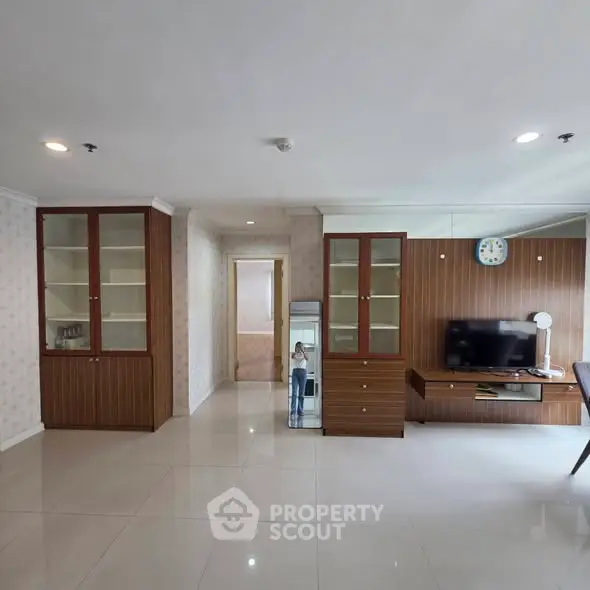 Spacious living room with modern furniture and elegant cabinetry