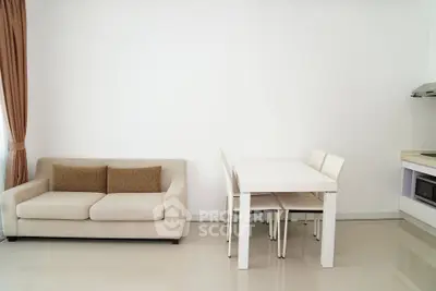 Modern minimalist living room with beige sofa and white dining set