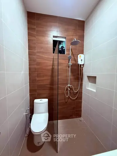 Modern bathroom with sleek shower and wooden accent wall