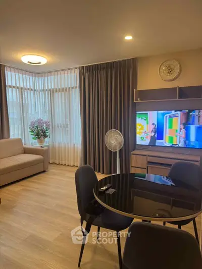 Modern living room with stylish furniture and large windows for natural light.