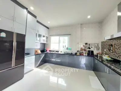 Spacious modern kitchen with sleek cabinetry and ample natural light.