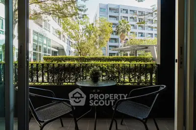 Charming balcony view with outdoor seating in modern apartment complex