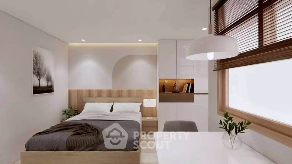 Modern bedroom with stylish decor and natural light, featuring a cozy bed and elegant furnishings.