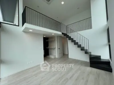 Modern duplex interior with sleek staircase and open layout