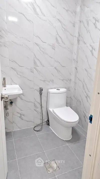 Modern bathroom with sleek tile design and compact fixtures