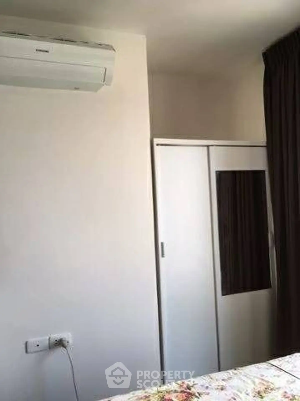 Cozy bedroom with air conditioning and wardrobe