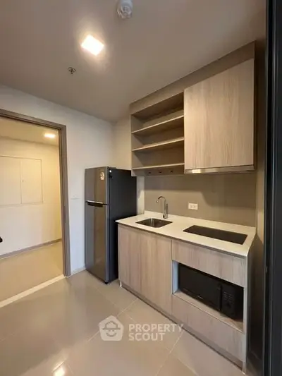 Modern kitchen with sleek cabinetry and appliances in a stylish apartment.